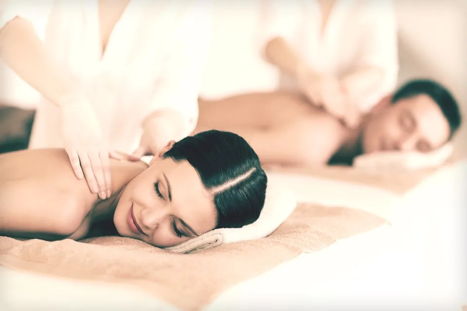 Two guests receiving a side-by-side couples massage