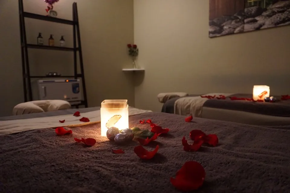 Candlelight and rose petals set out in the couples room